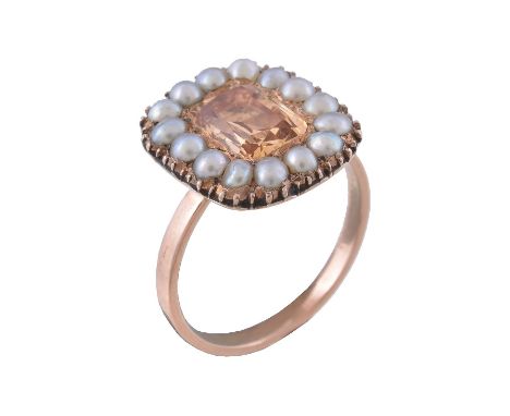  A golden topaz and pearl ring,   the mid 19th century cluster panel with a rectangular cut topaz within a surround of half p