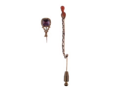 Ω A mid 19th century coral stick pin, circa 1860, the coral carved with a man's head, 5.5cm long; and an early Victorian foil
