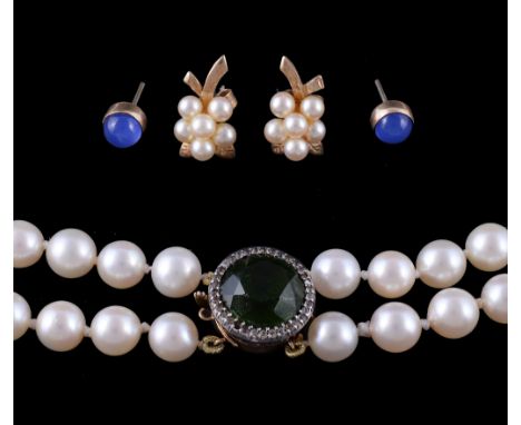  A two row cultured pearl necklace,   the graduated cultured pearls to a green stone and white paste set cluster clasp, 43.5c