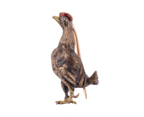  An early 20th century enamel and diamond cockerel brooch,   the textured body and neck with an enamel beak and comb, the eye