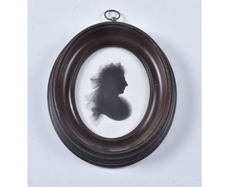John Miers (British, circa 1758-1821) Portrait of a lady   Silhouette painted on plaster   8.8cm x 6.7cm, oval   In an oval p