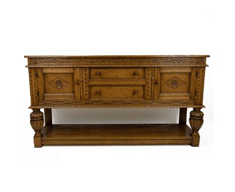Contemporary oak farmhouse plank top sideboard with carved frieze above two drawers flanked by two cupboards, all with carved