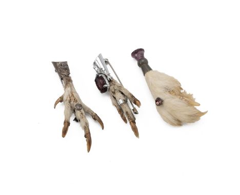 Three vintage Scottish brooches, each in the form of a grouse foot, one with an amethyst finial.