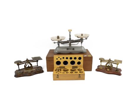 Two sets of vintage brass letter scales and weights, along with a cased set of brass weights and one other pair of weighing s