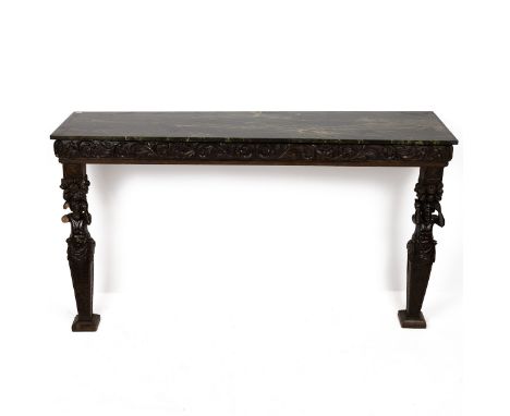 Continental carved and marble effect console table, late 19th Century. Front legs carved with a figure of Bacchus, carved aca
