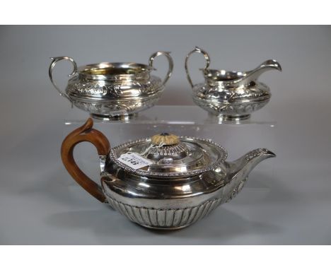 Early 19th century silver baluster shaped teapot with turned wooden handle, engraved armorial and fluted design. London 1818.