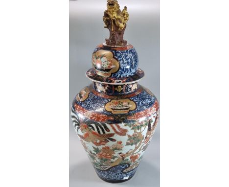 Impressive Japanese export baluster jar and cover, in the Imari pallet, decorated with birds amongst prunus and foliage, with