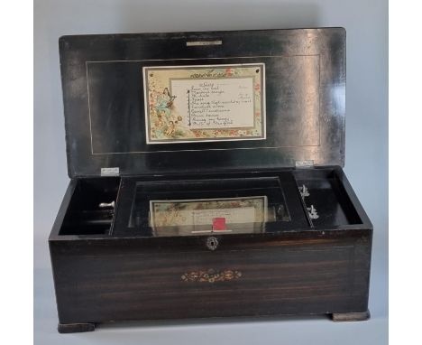 19th Century Swiss musical box, having inlaid and ebonised case with hinged cover revealing cylinder movement, having 8.5" st