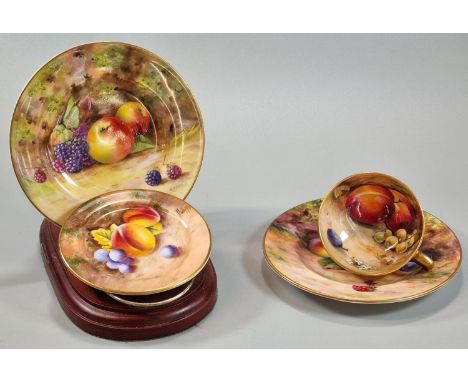 Royal Worcester porcelain demi-tasse cup, hand painted with fruits, signed Ricketts, together with two similar Royal Worceste