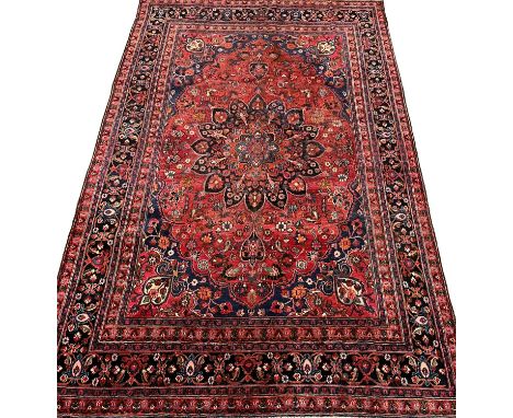 Vintage multi-coloured field Persian Kerman carpet, with central floral medallion and having repeating floral and foliate bor