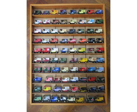 80 Lledo advertisng diecast vehicles in a wooden display shelf, 28.5" by 23 3/4".