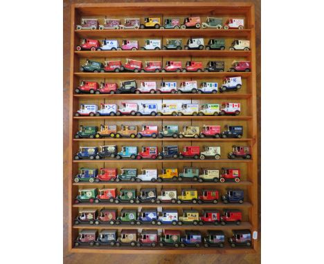 88 Lledo advertisng diecast vehicles in a wooden display shelf, 28.5" by 23 3/4".