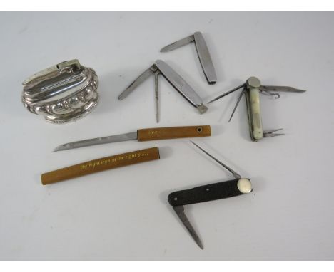 Vintage smokers penknives and a table lighter.