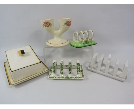 Mixed ceramics to include a Art deco butter dish, a double egg cup &amp; three toast racks, one by Booths and One by Masons.