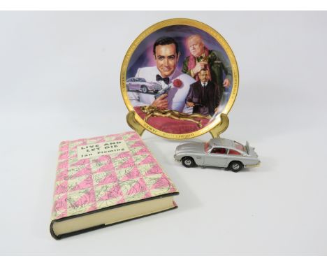 James Bond lot to include a Corgi 007 Aston Martin DB5, Live and let die book and a plate.