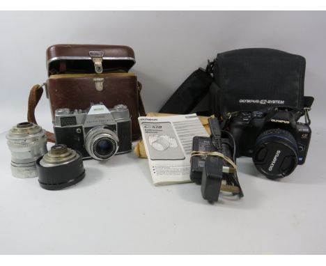 Olympus E-510 Digital SLR camera with accessories plus a vintage Kodak Retina Reflex.