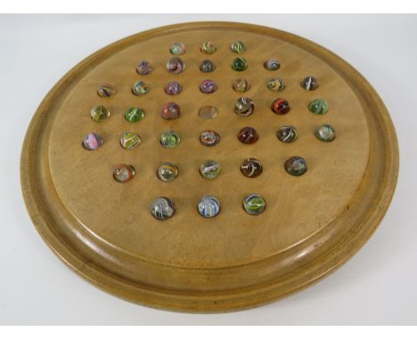 Large Solitare board and 36 antqiue marbles most with Lattice centres. The board measures 12 3/4" diameter.