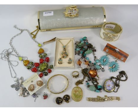 Mixed costume jewellery lot including a rolled gold bangle etc.