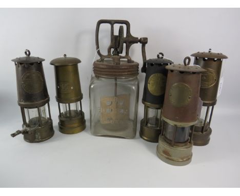 Five vintage Miners lamps and a vintage glass butter churn.