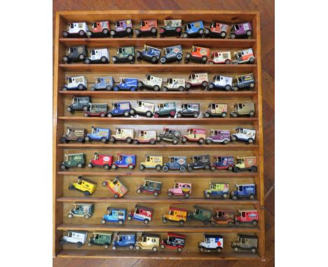 68 Lledo advertisng diecast vehicles in a wooden display shelf, 28.5" by 23 3/4".