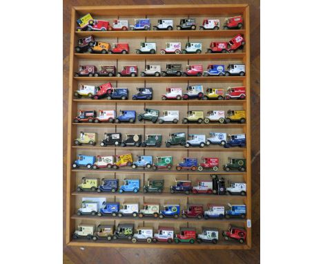 80 Lledo advertisng diecast vehicles in a wooden display shelf, 28.5" by 23 3/4".