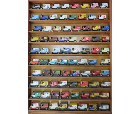80 Lledo advertisng diecast vehicles in a wooden display shelf, 28.5" by 23 3/4".