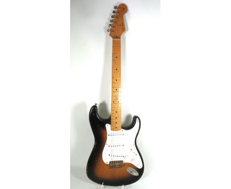 Copy of a 1950's Vintage Fender Stratocaster in Sunburst, Contour Body. In used condition. Cover to rear is missing.&nbsp; so