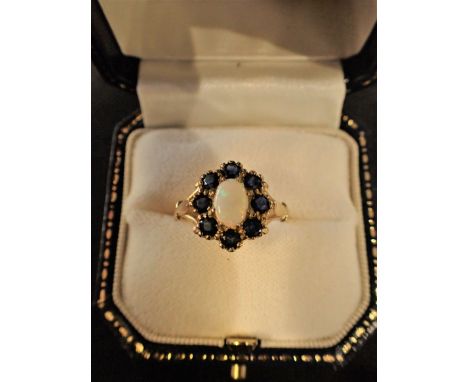 A 9CT GOLD, SAPPHIRE AND OPAL RING of flower head design, size R