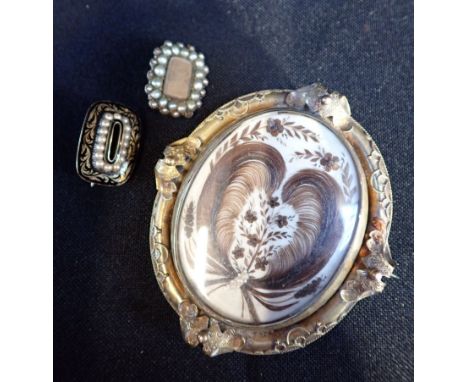 A VICTORIAN MOURNING BROOCH WITH ELABORATE HAIR ARRANGEMENT backed with a photo portrait, a yellow metal and enamel mourning 