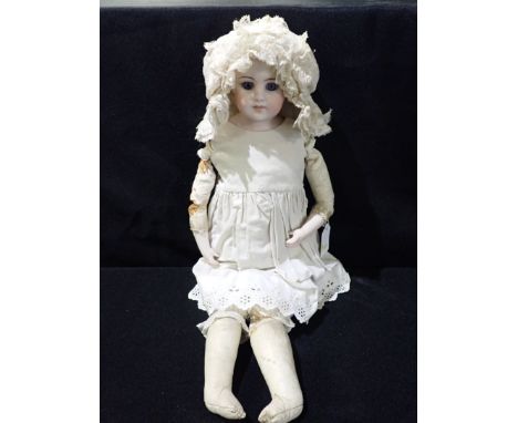 A BISQUE HEAD DOLL WITH KID LIMBS, IN THE STYLE OF JUMEAU and bisque hands, the head stamped '920', 48cm high