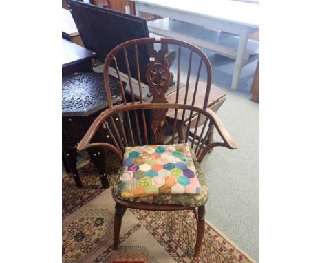 A 19TH CENTURY YEW WOOD AND ELM SEATED WHEELBACK WINDSOR ARMCHAIR with two tier comb back, on turned legs, 100cm high x 66cm 