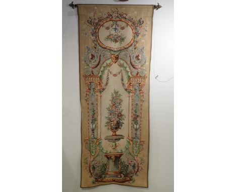 A MACHINED PENDANT TAPESTRY of 18th Century design, woven with vase of flowers under an arch, 182cm high x 72cm wide, with ha