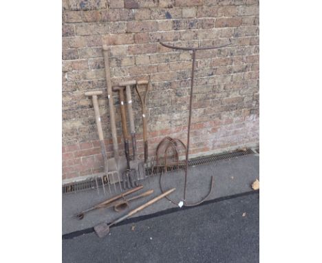 A COLLECTION OF ANTIQUE GARDEN TOOLS including border forks, spades and an iron support for a net. Provenance: The Richard Pr