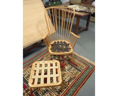 AN ERCOL ELM ARMCHAIR AND MATCHING STOOL 
