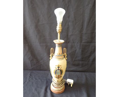 A ROYAL DOULTON STONEWARE TWO HANDLED ELECTRIC TABLE LAMP with raised leaf cartouches on a buff ground, 45 cm high, lacking s