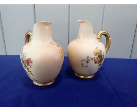 TWO ROYAL WORCESTER JUGS ivory ground with flower decoration and gilding, 14 cms high