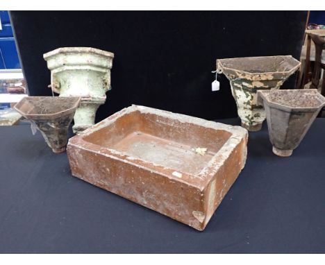 A SMALL GLAZED STONEWARE SINK 49 x 36cm (chipped and worn), and four cast-iron rainwater hopper heads. Provenance: The Richar