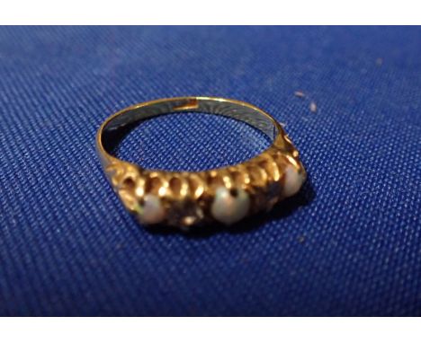 AN OPAL AND DIAMOND RING three opals, divided with two diamonds, on an 18ct gold shank ring size P