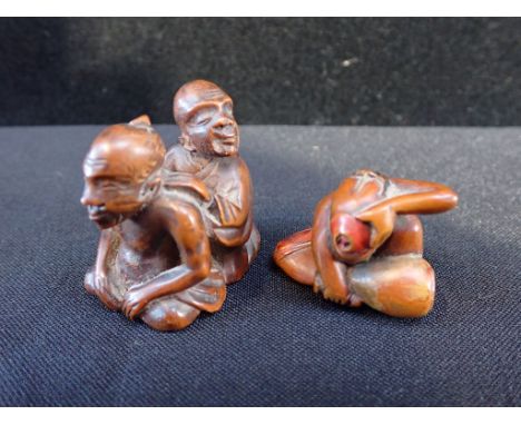 TWO JAPANESE CARVED WOODEN NETSUKE one a man drinking from a bowl