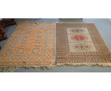 A KAZAK STYLE RUG woven with three lozenge medallions on a mushroom colour ground within multiple borders, 170cm x 120 cm, su