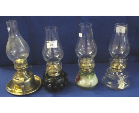 Group of four single burner chamber type oil lamps, two glass, one brass, one ceramic, all with clear chimneys. (4)(B.P. 24% 