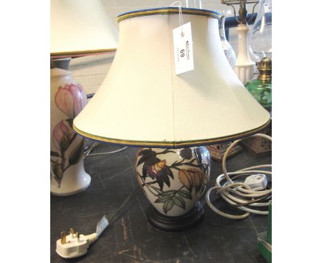 Moorcroft Art Pottery lamp base, tube lined, with leaves on a cream ground, wooden base and fabric shade.(B.P. 24% incl. VAT)