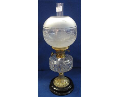 Early 20th Century brass double burner oil lamp with moulded clear glass reservoir on fluted brass pedestal with ceramic base