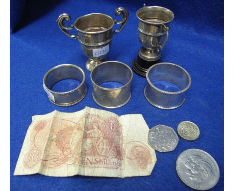 Bag of assorted silver napkin rings, miniature trophy cups, crowns etc.(B.P. 24% incl. VAT)