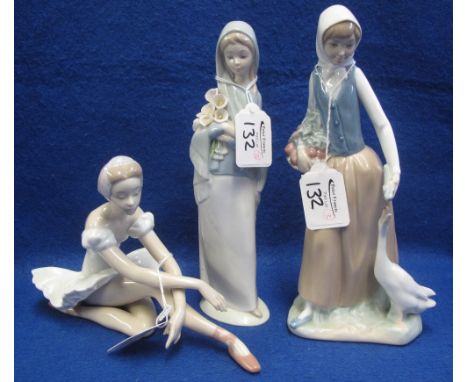 Three Spanish porcelain figurines to include: Lladro porcelain ballerina; Lladro porcelain girl with lilies and a Nao porcela