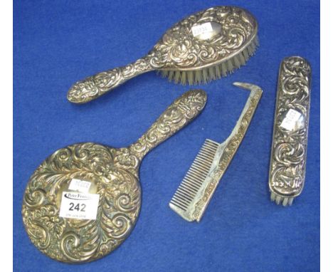 Repousse silver backed dressing table set, two brushes, mirror and comb.(B.P. 24% incl. VAT)