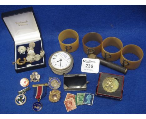 A collection of costume jewellery and napkin rings including a dashboard clock.  (B.P. 24% incl. VAT)