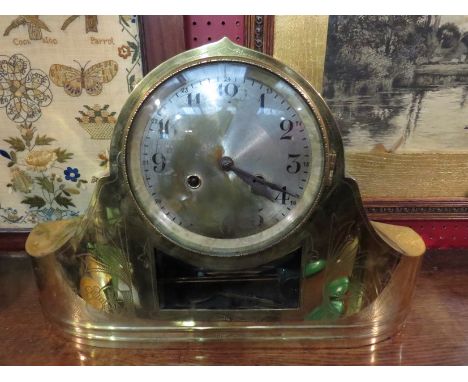 A brass cased mantel clock, engraved decoration on front. Silvered dial, 8-day spring-driven time and strike movement by Hall