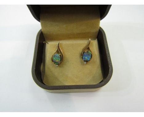 A pair of opal and diamond chip stud earrings in Sherman Opals box