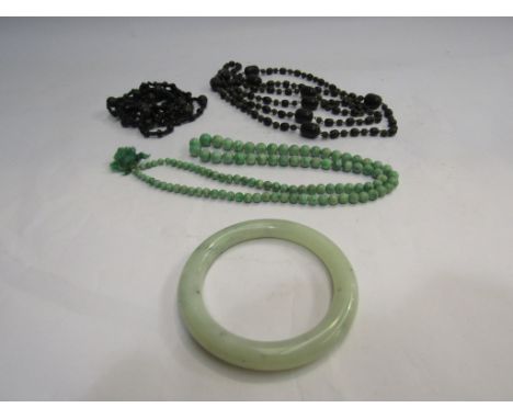 A jade bangle, beaded necklace and black bead necklace